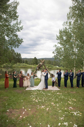 Bohemian wedding style of outdoor wedding with rug and flower petals