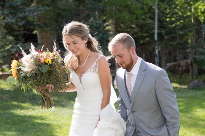 Jade and Brannon walk to their car after their summertime outdoor wedding ceremony