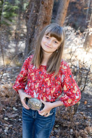 4H junior national champion has fall portraits shot with her belt buckle in Taos Canyon