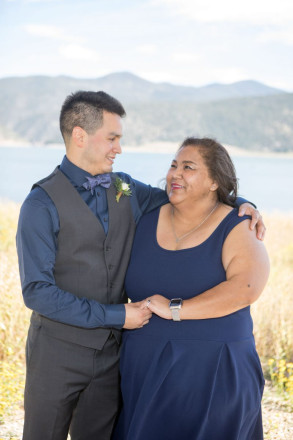 Israel and his mom smile at each other in front of Eagle Nest Lake