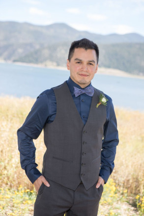 Israel, in a purple bowtie, poses for a wedding photo at Eagle Nest Late