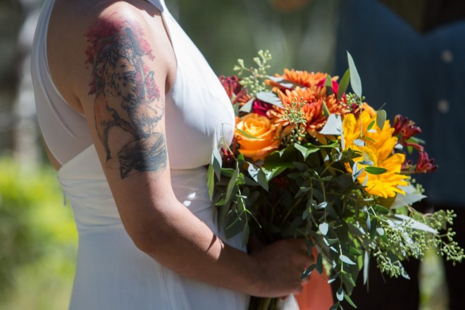 Sarah's tattoo was so contrasty with her bouquet and wedding dress