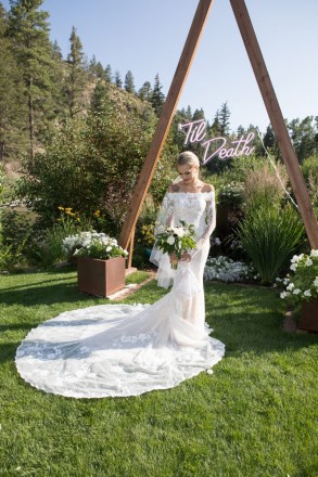 Lovely bride, Courtney with wedding dress train, bouquet, and 'Til Death altar sign