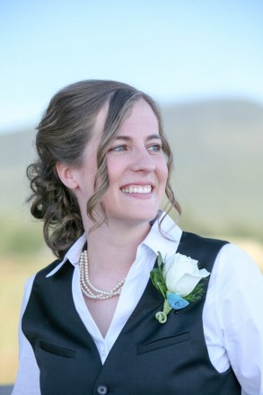 Bride with boutonniere, vest, and pearls