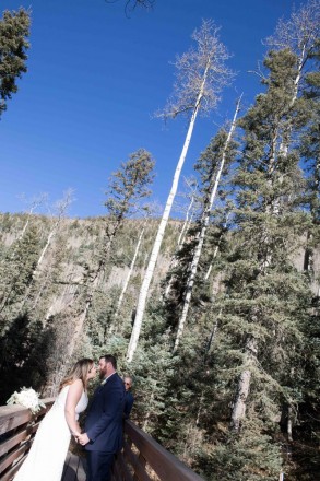 Sabrina and Joshua lean in for their kiss after their Taos Ski Valley wedding ceremony