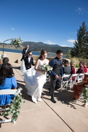 Victoria and Israel walk down the aisle with Victoria's sister carrying her dress