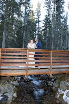 Sabrina and Joshua at Taos Ski Valley over small falls in forest setting