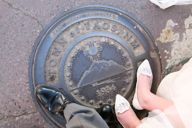 Beautiful Taos, NM manhole cover featuring mountains and Zia