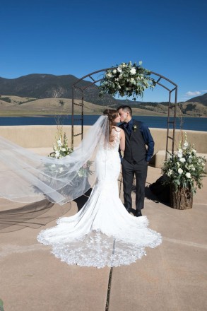 Victoria and Israel kiss during an altar picture at Eagle Nest Lake