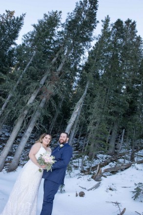 Wedding couple with snow and pine trees at TSV wedding