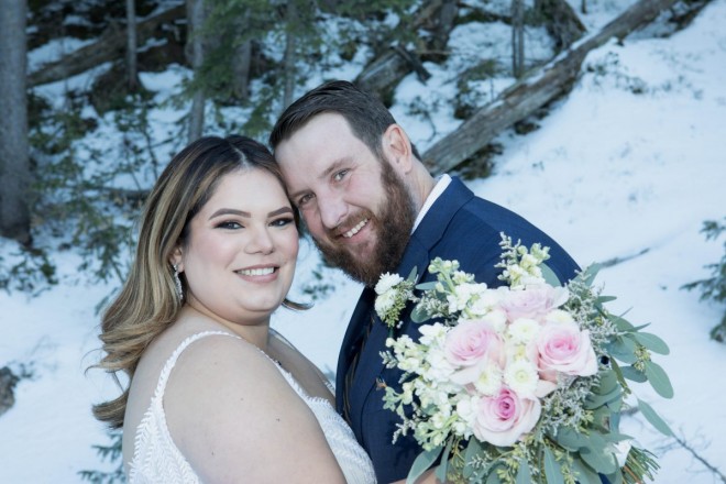 Sabrina and Joshua in snow in October at their Taos Ski Valley wedding