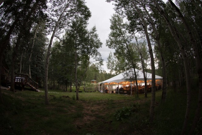 Outdoor setting with wedding tent and aspen trees in Taos Canyon