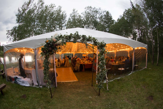 Gorgeous ambient lighting in tent rental in Taos Canyon for wedding reception