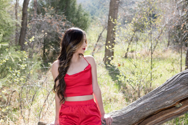 Beautiful high school senior's profile with red lipstick and red outfit