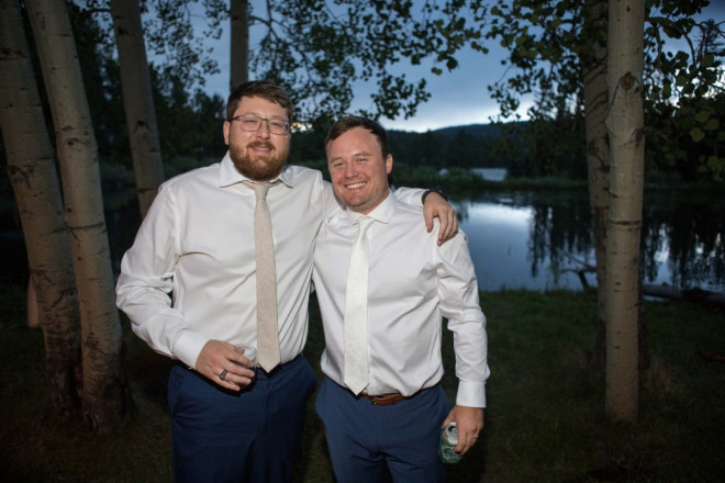 Groomsmen standing next to aspens and the pond in Valle Esondido