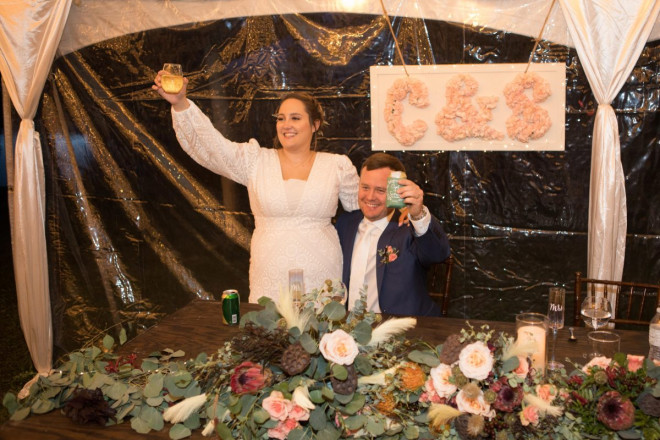 Scarlet and Clint raise their glass during a toast at their Taos reception