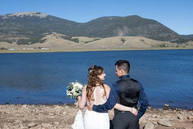 Victoria and Israel smile at a job well done after their Eagle Nest wedding