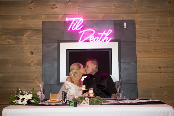 Courtney and Travis kiss under hot pink 'Til Death sign