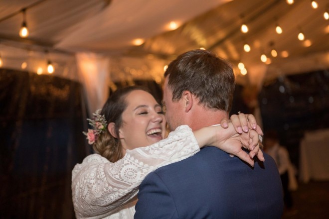Scarlet and Craig share a laugh during their Taos wedding reception in a tent