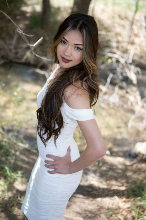 Jenica, with nose ring and gorgeous long hair, poses with her hand on her hip in Taos Canyon