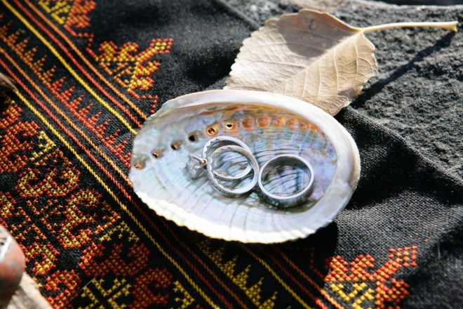 Wedding rings in a shell during autumn wedding ceremony