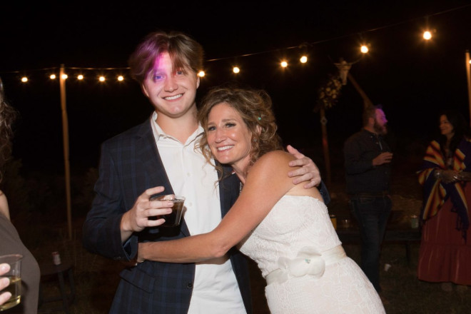 Chasity hugs her son at her outdoor El Prado wedding reception