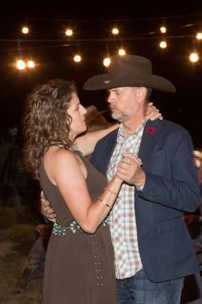 Wedding guests dance outside after dark at this Taos reception