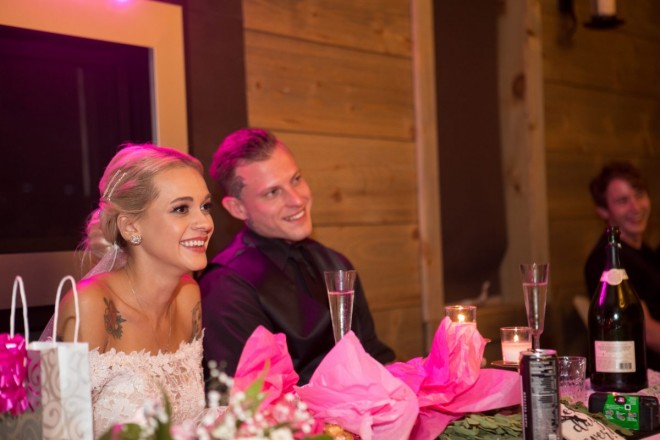 Hot pink lighting and décor and a beautiful tattooed bride and groom