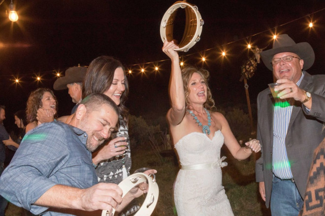 Outdoor September wedding reception in Taos, NM with tambourines