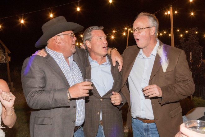 Groom with friends drink shots and sing to reception DJ