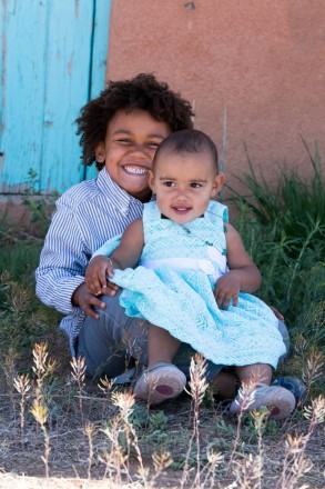 Taos kids portraits with New Mexico's iconic colors, turquoise and adobe.