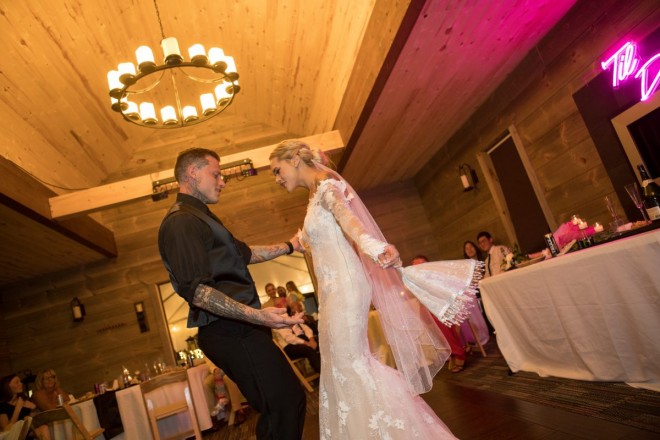 Courtney and Travis dancing their first dance in front of reception guests