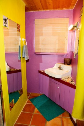 Purple and yellow walls with Saltillo tile in Taos, NM
