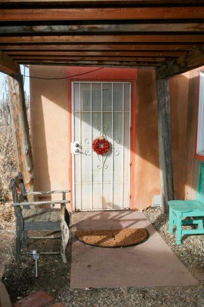 Bared door entrance for adobe home rental in Taos